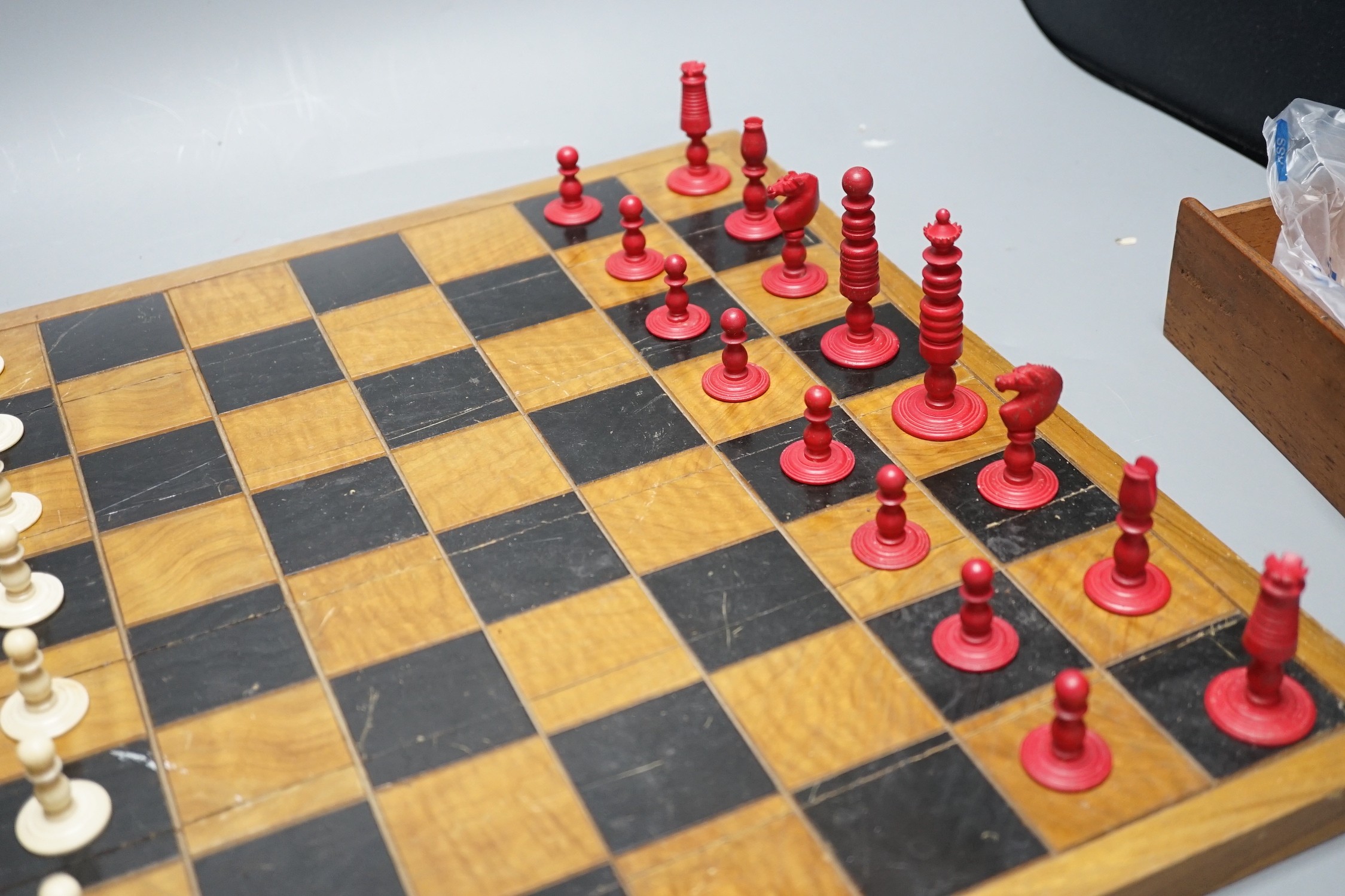 A 19th century bone chess set, Kings 7 cm with a later inlaid chessboard chess board